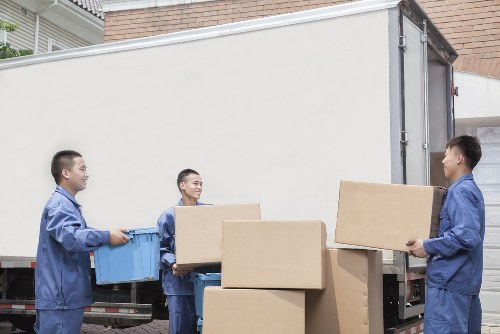 Removal team planning a flat move in Hackney with packed boxes and furniture